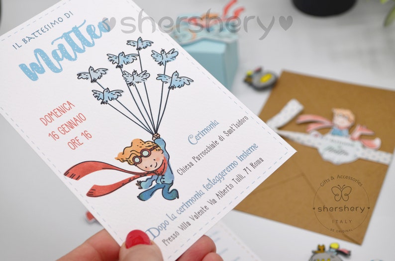 May include: A white invitation card with blue and red illustrations. The card features a boy holding balloons with birds on them. The text on the card reads "IL BATTESIMO DI Matteo DOMENICA 16 GENNAIO ORE 16 Cerimonia Chiesa Parrocchiale di Sant'Isidoro Dopo la cerimonia festeggeremo insieme Presso Villa Valente Via Alberto Tulli, 71 Roma"