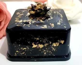 Forbidden Rose Resin Jewelry Box is a black and gold handmade square shaped organizer with a flower on top that can be used for storage