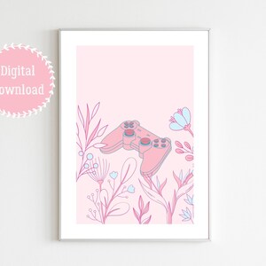 May include: A framed digital print featuring a pink video game controller surrounded by floral illustrations in pink, blue, and purple hues. The words "Digital Download" are in a pink circle in the upper left corner.