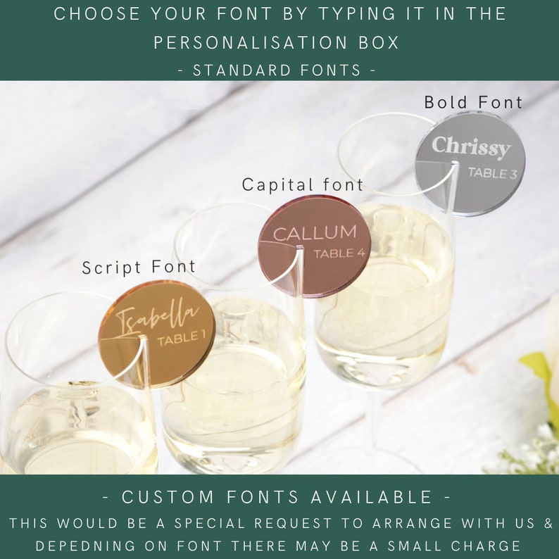 May include: Three clear glass champagne flutes with gold, silver and brown acrylic table number place cards. The place cards have different fonts and the text "Chrissy Table 3", "Callum Table 4", and "Isabella Table 1".