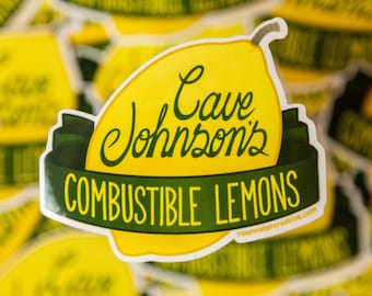 May include: A yellow lemon sticker with a green banner that reads "Cave Johnson's Combustible Lemons" and the website "rosewatercreative.com".