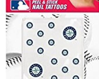 May include: Peel and stick nail tattoos featuring the Seattle Mariners logo and baseball stitching. The package has a red top with the MLB logo and the words "PEEL & STICK NAIL TATTOOS". The nail art stickers are white with blue and white accents.