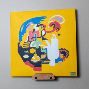 May include: A yellow vinyl record with an abstract design featuring a blue, red, white, and black pattern. The record is titled "PARALLEL LINES" and has a Parental Advisory sticker in the bottom right corner.