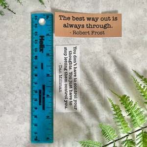 mental health quotes in Kraft brown and white sticker paper strips next to a blue ruler that shows they are 1.20 in.(H) X 3.25 in. (W)