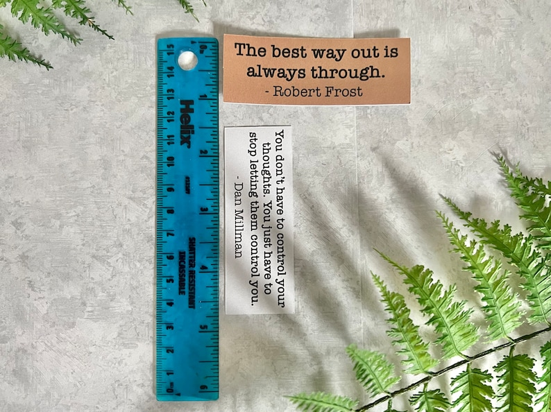 mental health quotes in Kraft brown and white sticker paper strips next to a blue ruler that shows they are 1.20 in.(H) X 3.25 in. (W)