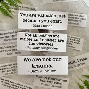mental health quotes by various authors in white sticker paper strips.