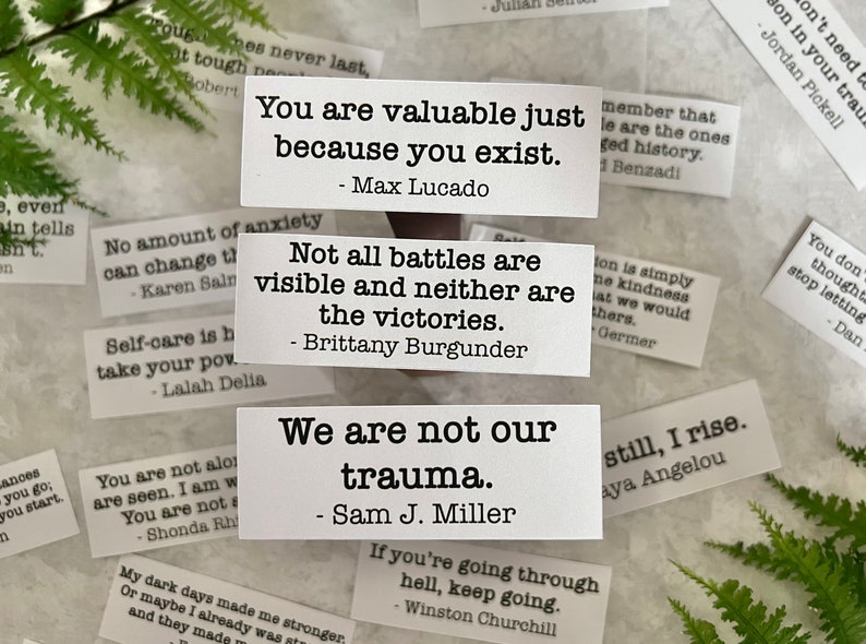 mental health quotes by various authors in white sticker paper strips.