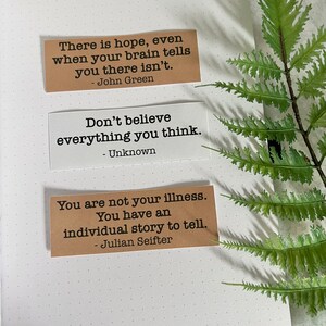 Mental health Quotes by various authors in Kraft brown and white sticker paper strips on an A5 dotted journal.