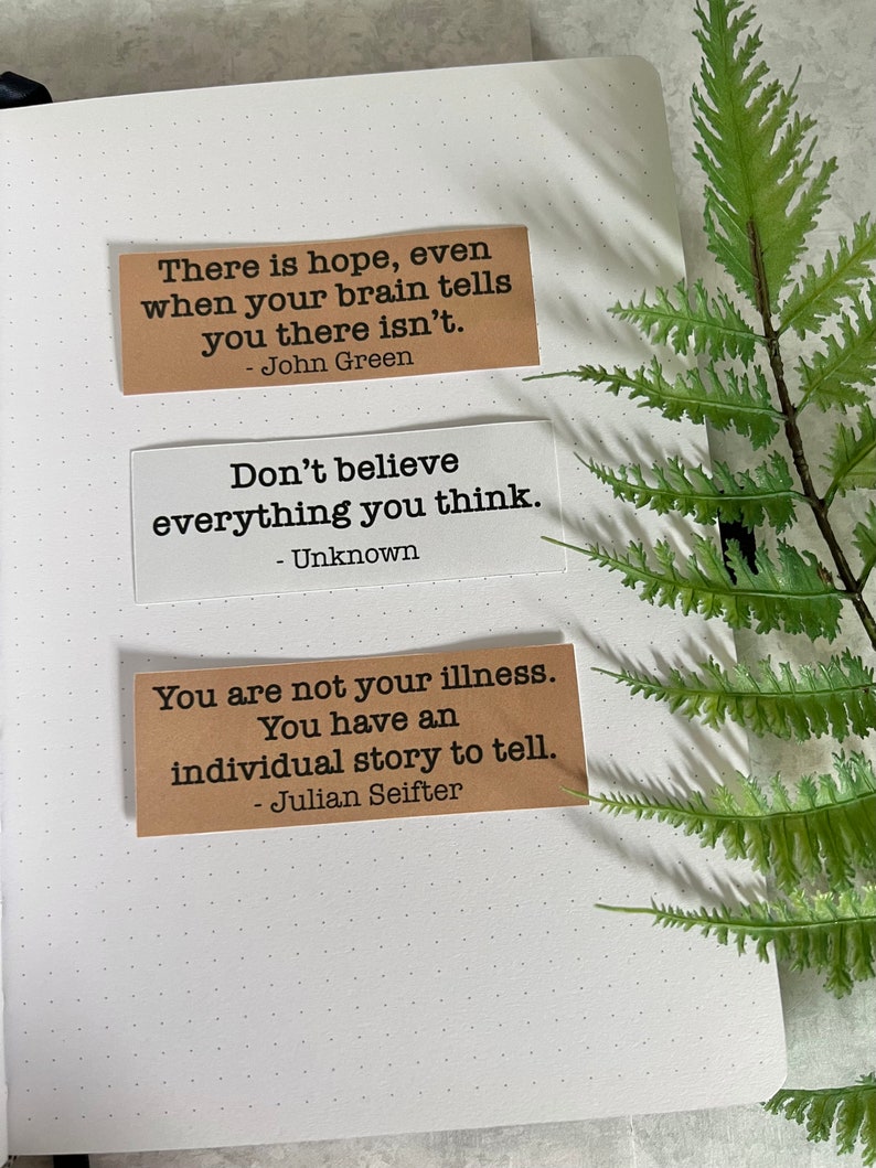 Mental health Quotes by various authors in Kraft brown and white sticker paper strips on an A5 dotted journal.