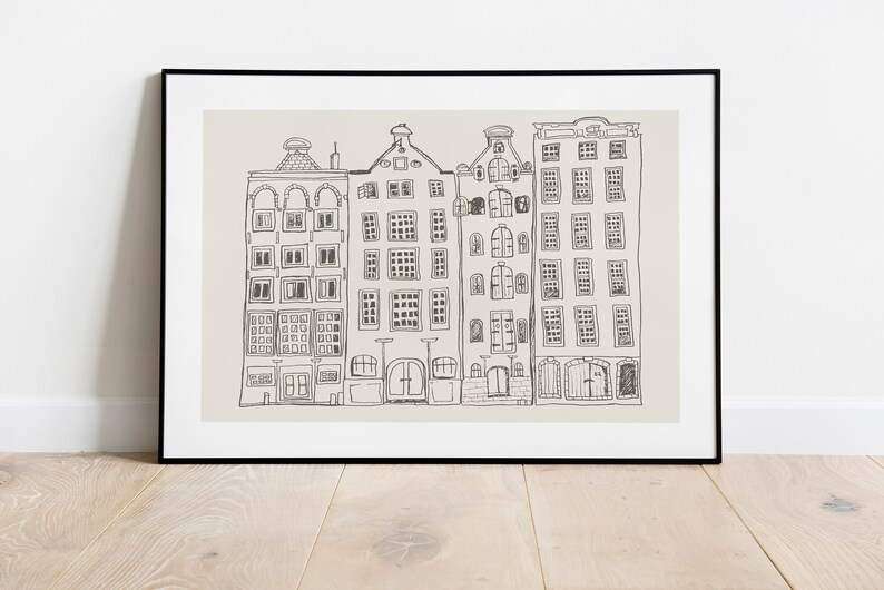 May include: A framed wall art print featuring a black line drawing of four narrow, multi-storey canal houses with varied gabled roofs and numerous rectangular windows, set against a solid light beige background within a thin black frame.