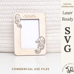 May include: A wooden picture frame with a cutout of two seahorses. The frame has the text "salt air, sand & good memories" at the top.
