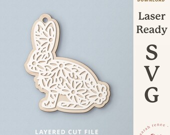 May include: A white laser cut file of a bunny rabbit with a floral pattern. The file is layered and ready for commercial use.