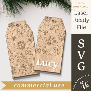 May include: Two wooden Christmas gift tags with a white outline of a Christmas tree, snowflakes, gingerbread men, and presents. The tags are laser cut and ready to be personalized. The text "Lucy" is written on one of the tags.