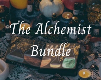 May include: A black and gold box with the text "The Alchemist Bundle" on it. The box is surrounded by various bottles, candles, and other items.