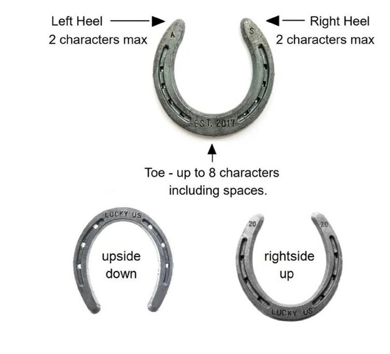May include: Two silver horseshoes with the words "LUCKY US" and "EST. 2017" engraved on them. The horseshoe on the left has the words "upside down" written on it. The horseshoe on the right has the words "rightside up" written on it.