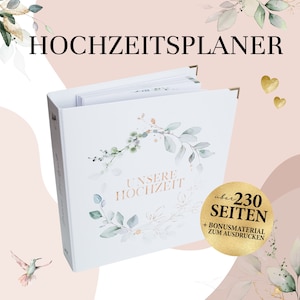 Könnte beinhalten: Ein weißes Hochzeitsplaner-Buch mit goldenen Eckschützern. Das Cover zeigt ein Aquarell-Kranz-Design und die Worte "UNSERE HOCHZEIT". Das Buch hat über 230 Seiten und Bonus-Druckmaterial.