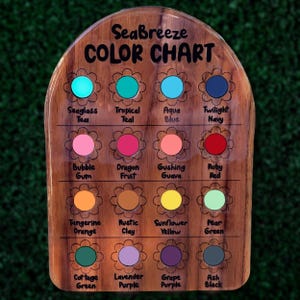 May include: Wooden color chart labeled "Seabreeze COLOR CHART" with 16 color swatches in flower-shaped frames. Colors include teal, blue, pink, orange, yellow, and purple. Each color is labeled with its name.