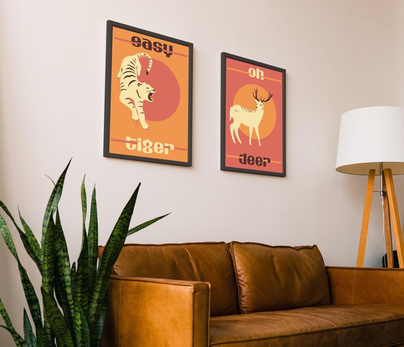 May include: Two framed prints with a retro design. The left print features a tiger with the text "easy tiger". The right print features a deer with the text "oh deer".