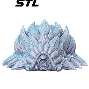 May include: A 3D-printed sculpture with a stylized, layered design in shades of gray and blue. The sculpture has a central, eye-like feature and the text "STL" in black at the top. The overall shape resembles a stylized plant or organic form.