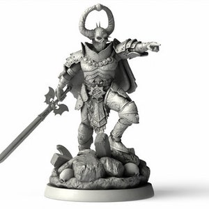 May include: A gray, detailed miniature figurine of a demon knight wearing armor and holding a sword. The knight is standing on a rocky base with skulls and other debris.