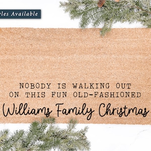 May include: A brown coir doormat with the text "NOBODY IS WALKING OUT ON THIS FUN OLD-FASHIONED Williams Family Christmas" printed in black.
