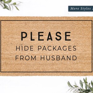 May include: A brown doormat with the text "PLEASE HIDE PACKAGES FROM HUSBAND" in black lettering.
