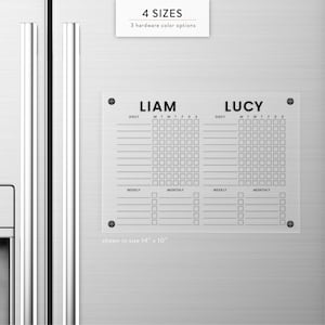 May include: A clear acrylic chore chart with the names "LIAM" and "LUCY" printed in black. The chart includes daily, weekly, and monthly task sections. The size shown is 14" x 10". The text "4 SIZES" and "3 hardware color options" are also visible.