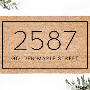 May include: A brown doormat with a black border and the number 2587 and the text "Golden Maple Street" printed on it.