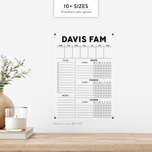 May include: A clear acrylic family chore chart with the text "DAVIS FAM" at the top. It includes sections for "TO DO", "NOTES", and chore tracking for David, Charlie, and Lauren. The chart is shown in a 28"x20" size.