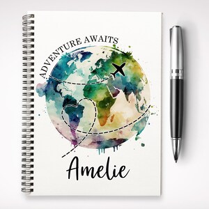 May include: A watercolour illustration of a globe with a plane flying over it. The globe is surrounded by a dotted line and the words "Adventure Awaits" are written above it. The name "Amelie" is written below the globe.