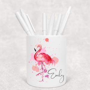 May include: White ceramic pencil holder featuring a pink flamingo illustration with watercolour splatters. The name "Emily" is written in cursive on the holder.