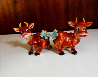 Norcrest ceramic COW & BULL Salt 'n Pepper Shaker Set ~ Vintage Hand Painted Anthropomorphic Bessie Brown Figurines w/ Blue Tail Bows