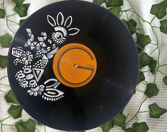 May include: Black vinyl record with a white geometric design painted on the surface. The record label is orange and features the text "CLAUDIO BARTOLI" and "GAMMA".