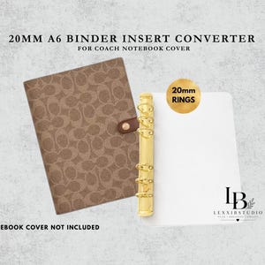 May include: A 20mm A6 binder insert converter for a Coach notebook cover, featuring a brown patterned notebook cover with a snap closure and a gold-colored metal ring mechanism with 20mm rings attached to a white rectangular insert plate.