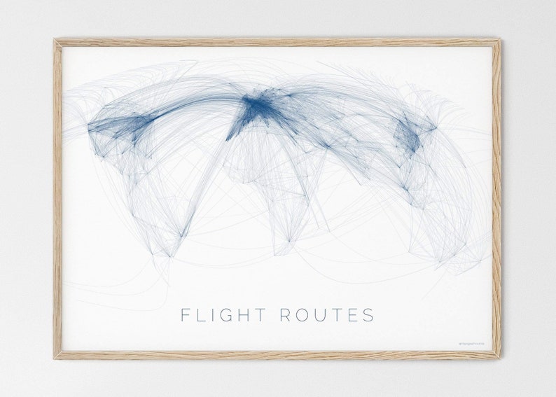 May include: A framed print of a world map with blue lines representing flight routes. The text "FLIGHT ROUTES" is printed below the map.