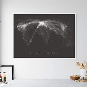 May include: A black and white print of a world map with flight routes highlighted in white. The text "FLIGHT ROUTES" is printed in white at the bottom of the print.