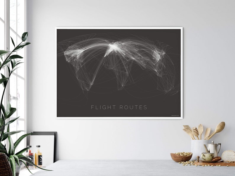 May include: A black and white print of a world map with flight routes highlighted in white. The text "FLIGHT ROUTES" is printed in white at the bottom of the print.