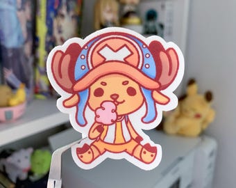May include: A cartoon sticker of a character with red hair, a blue and white hat, and a pink cotton candy. The character is wearing a yellow and red outfit and is sitting down.