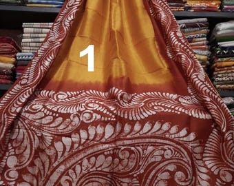 May include: A draped textile with a vibrant color scheme. The top portion is a golden yellow, transitioning to a deep red with a white, ornate, paisley-like pattern. The number "1" is prominently displayed.