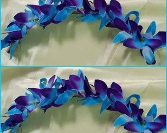 May include: Two blue and purple orchid leis, each with a row of flowers connected by a green stem. The leis are arranged in a semi-circle shape, with the flowers facing outwards.