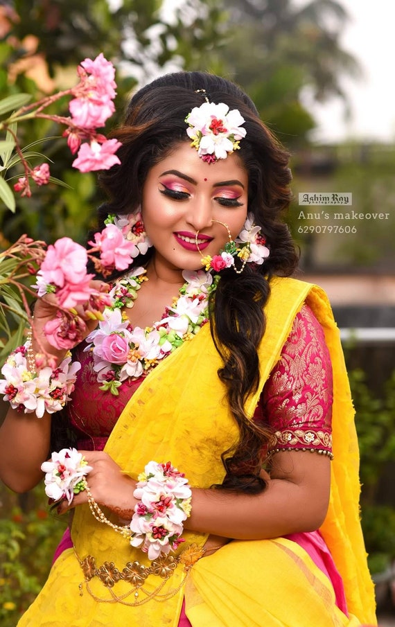 Premium Photo | A woman in a red sari with a gold nose ring and a gold nose  ring.