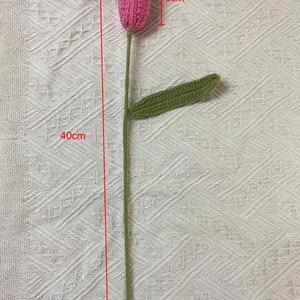 May include: A pink crocheted tulip flower with a green crocheted leaf. The stem is 40 cm long, the flower is 6 cm tall and 3 cm wide.
