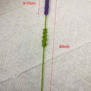May include: A purple and green artificial lavender flower stem, approximately 9-10 inches tall and 40 inches long.
