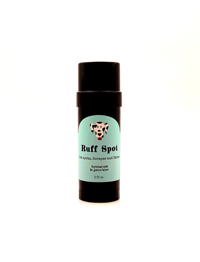 May include: A black cylindrical product labeled "Ruff Spot" with a light blue label. The label features a dalmatian dog illustration and text indicating the product is for hot spots, scrapes, and itches. It is enriched with St. John's Wort and contains 2.25 oz.