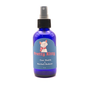 May include: A blue glass bottle with a white cat illustration and the text "Pretty Kitty Coat Health + Hairball Reducer 4 oz".