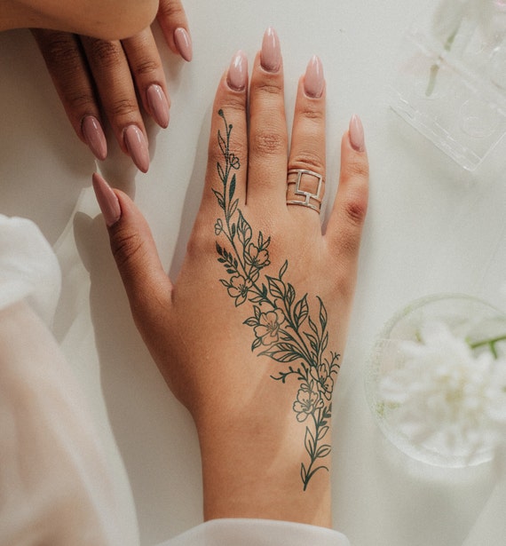 Flower vine tattoo on the right hand