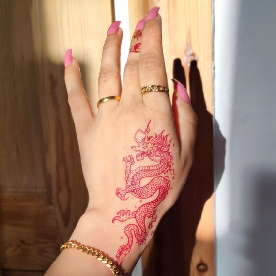 red dragon  Hand and finger tattoos Cute hand tattoos Red ink tattoos