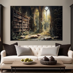May include: A white sofa with brown and white pillows sits in front of a large canvas print depicting a library overgrown with vines and sunlight streaming through arched windows.  The canvas print is framed in a dark wood frame.  The sofa is in a living room setting with a coffee table and two end tables with lamps.