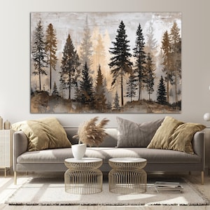 May include: Large rectangular canvas art featuring a forest scene with tall, slender trees in shades of black, brown, and gold. The artwork has a textured, abstract background, creating a sense of depth and atmosphere. The painting is displayed above a gray sofa.