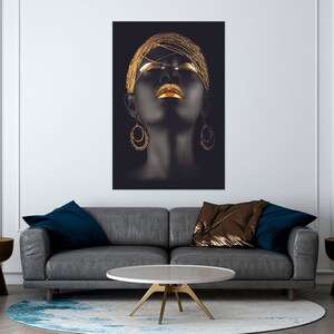 May include: A black and gold portrait of a woman with her eyes closed and gold jewelry. The woman's face is painted with gold makeup and she is wearing gold earrings.